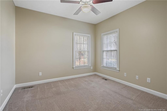 unfurnished room featuring a ceiling fan, carpet flooring, and baseboards