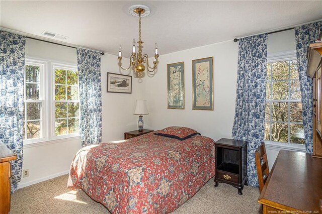 bedroom with visible vents, baseboards, carpet, and an inviting chandelier