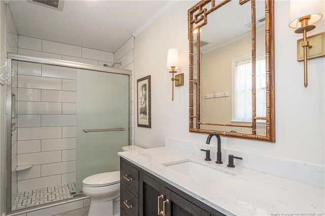 bathroom with visible vents, a stall shower, toilet, and ornamental molding