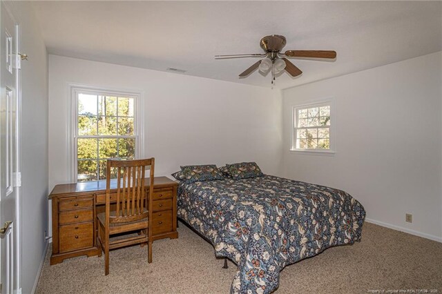 bedroom featuring carpet flooring, a ceiling fan, and baseboards