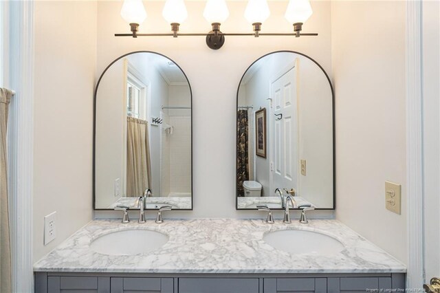 full bathroom with double vanity and a sink