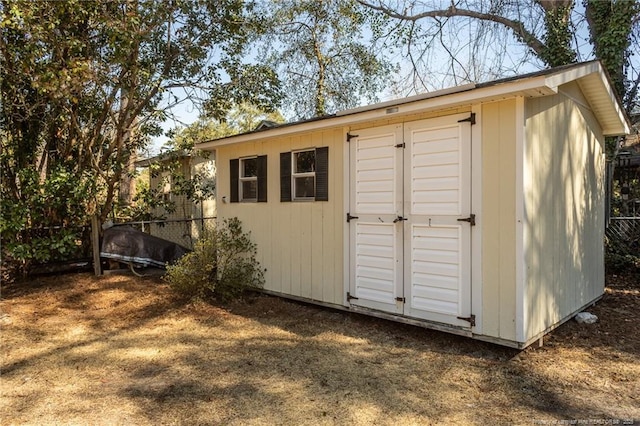 view of shed featuring fence