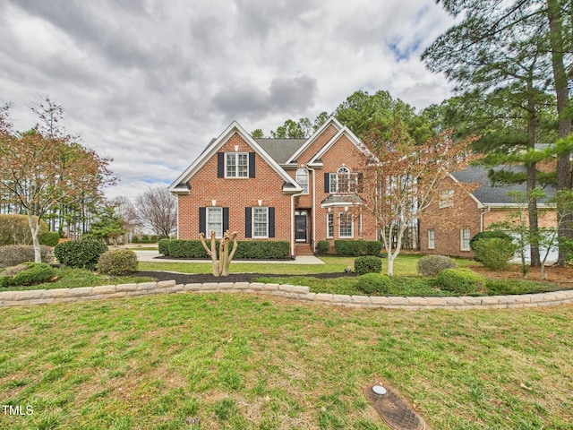 view of front facade featuring a front lawn and brick siding