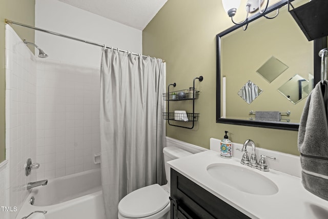 bathroom with a textured ceiling, vanity, shower / bath combo with shower curtain, and toilet