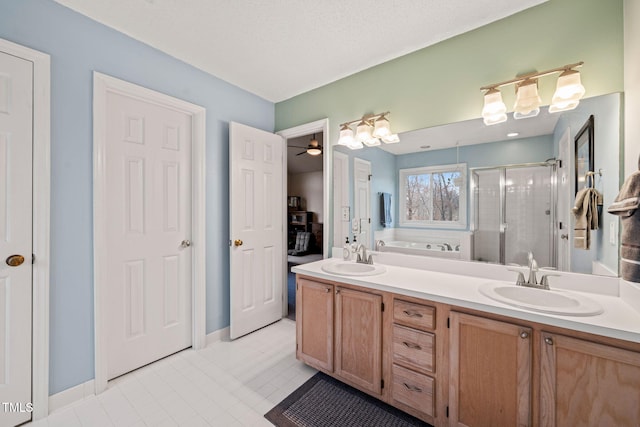 bathroom featuring a stall shower, a garden tub, a sink, and double vanity