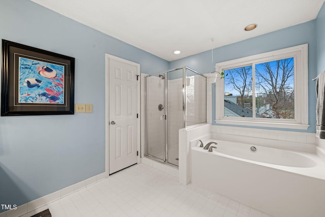 bathroom with tile patterned floors, a shower stall, baseboards, and a bath