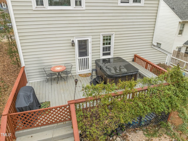 wooden deck featuring a jacuzzi