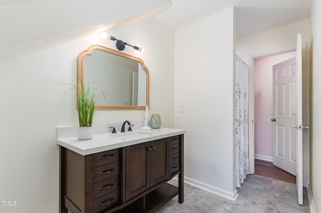 full bathroom with baseboards and vanity