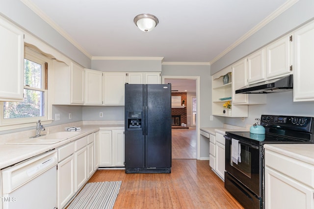 kitchen featuring under cabinet range hood, black appliances, light wood-style flooring, and light countertops