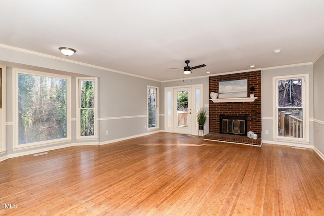 unfurnished living room with a fireplace, a ceiling fan, wood-type flooring, and ornamental molding