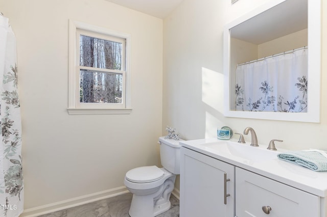 full bathroom featuring vanity, toilet, and baseboards