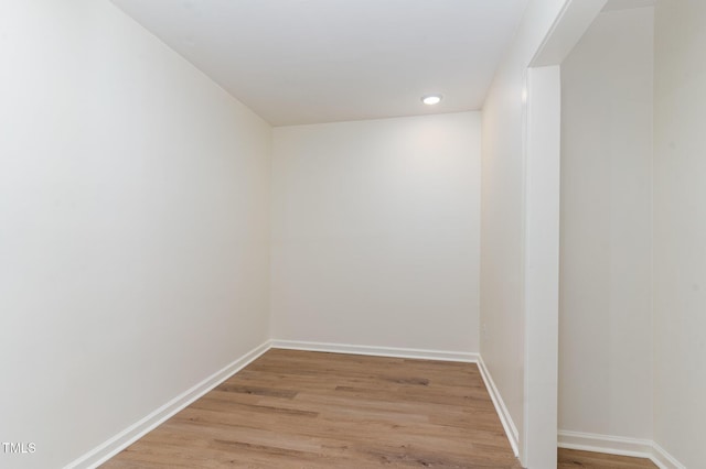 unfurnished room with baseboards and light wood-type flooring