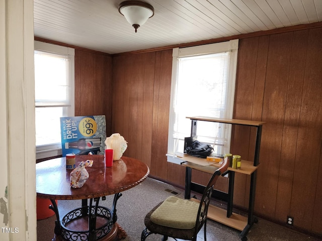 carpeted office featuring wood ceiling, wood walls, and visible vents