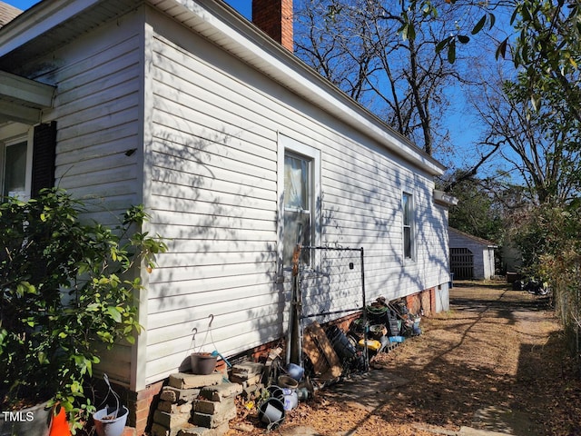 view of property exterior with a chimney