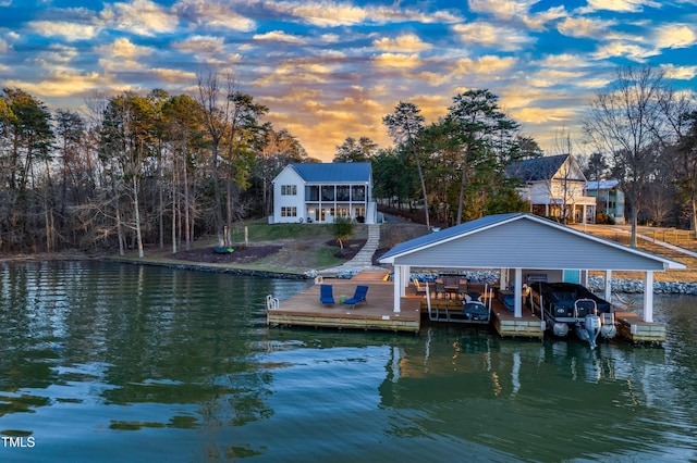 dock area with a water view and boat lift