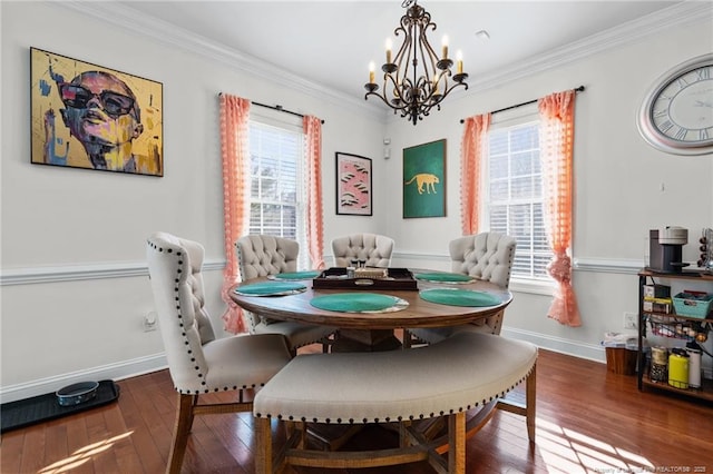 dining area with hardwood / wood-style flooring, a wealth of natural light, baseboards, and crown molding