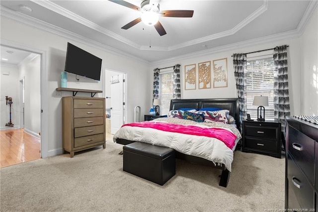 bedroom with multiple windows, crown molding, light carpet, and baseboards