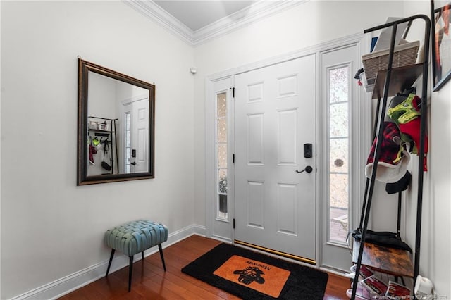 foyer with dark wood-style floors, crown molding, and baseboards