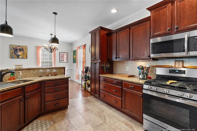 kitchen with decorative light fixtures, stainless steel appliances, backsplash, ornamental molding, and a sink