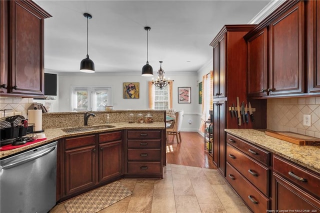 kitchen featuring decorative light fixtures, ornamental molding, a sink, dishwasher, and a peninsula