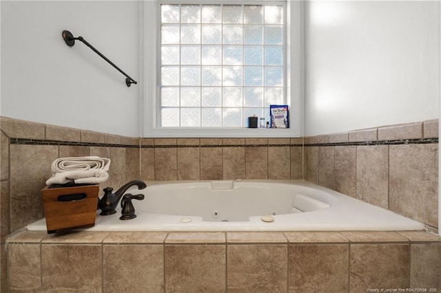 bathroom with a tub with jets