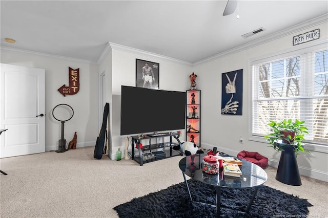 carpeted living room featuring a healthy amount of sunlight, visible vents, crown molding, and baseboards