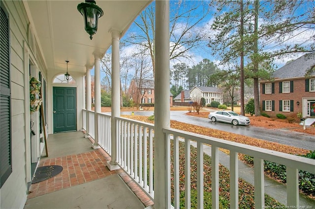 balcony featuring covered porch and a residential view