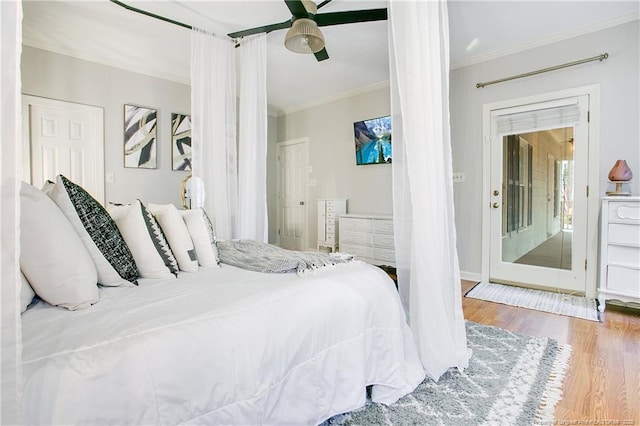 bedroom featuring ceiling fan, wood finished floors, and crown molding