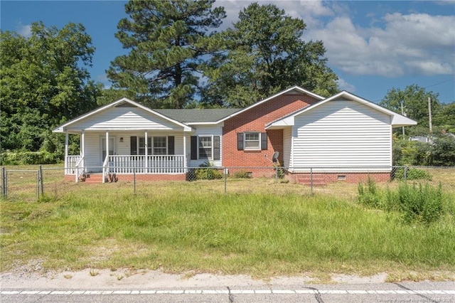 view of front of house with crawl space, fence private yard, a porch, and brick siding