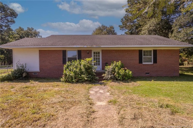 ranch-style house with crawl space, brick siding, a front lawn, and roof with shingles