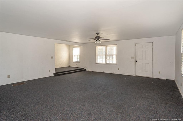 unfurnished room featuring visible vents and a ceiling fan