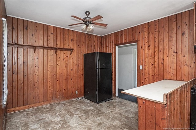 unfurnished room with ceiling fan and wooden walls