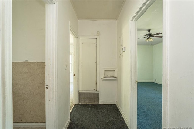 hall featuring visible vents, carpet flooring, and ornamental molding