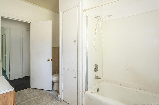 bathroom featuring toilet, shower / washtub combination, and vanity