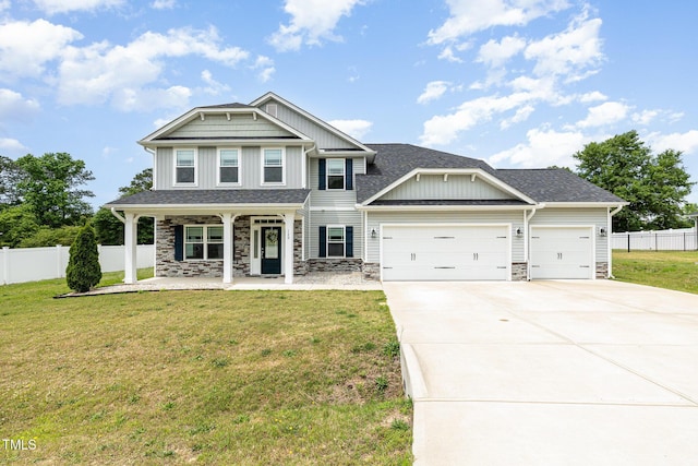 craftsman-style home with an attached garage, covered porch, stone siding, and driveway