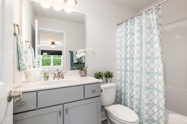 bathroom featuring toilet, vanity, and ceiling fan