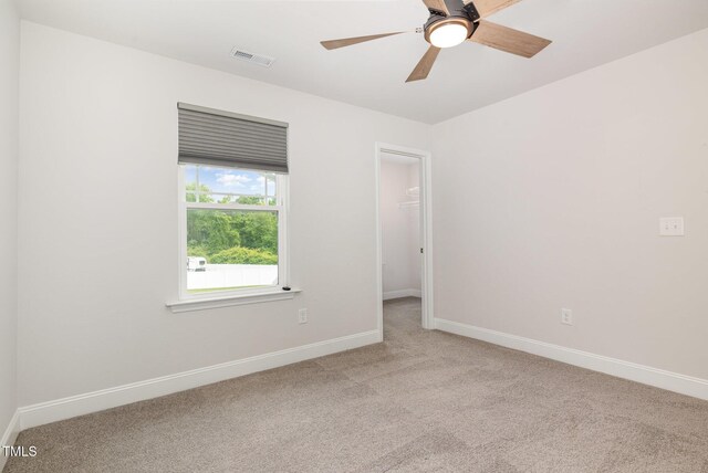 spare room featuring carpet flooring, baseboards, and a ceiling fan