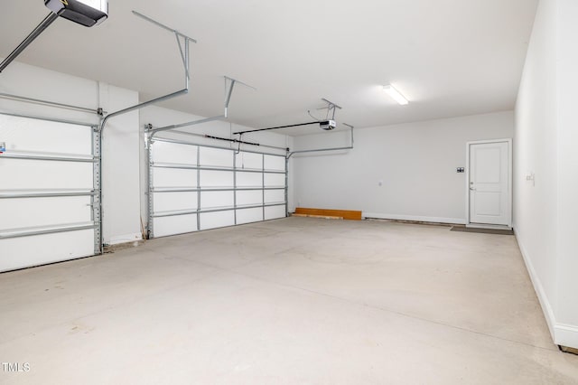 garage with a garage door opener and baseboards