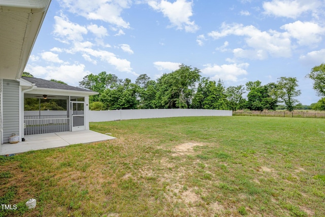 view of yard with a patio area, a sunroom, and ceiling fan