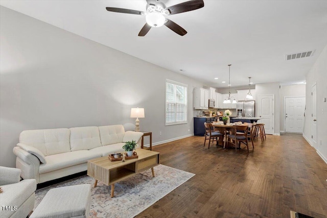 living room featuring dark wood-style floors, recessed lighting, visible vents, and baseboards