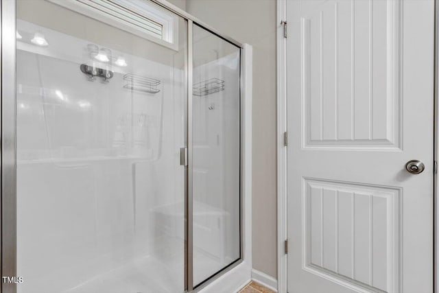 bathroom featuring a shower stall