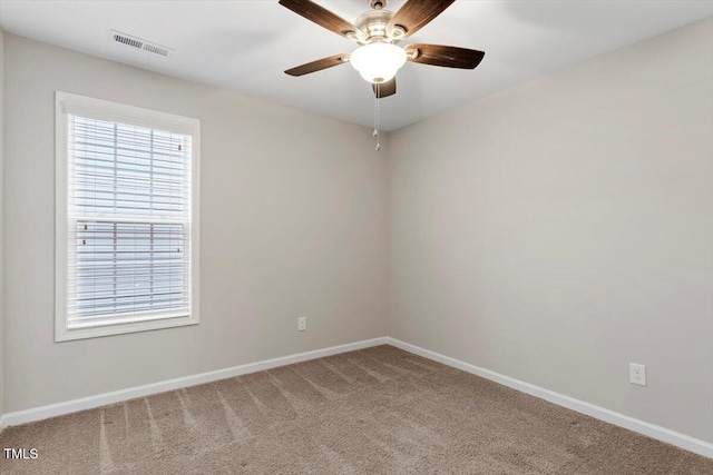 spare room with a ceiling fan, baseboards, visible vents, and carpet flooring