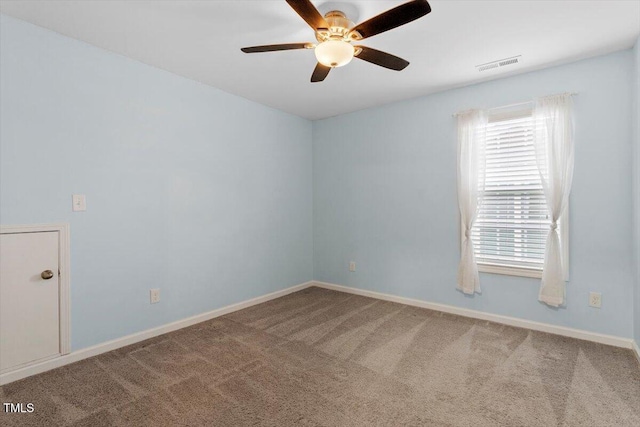 spare room with plenty of natural light, carpet flooring, visible vents, and baseboards