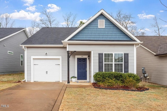 view of front of property featuring a garage, driveway, and a front lawn