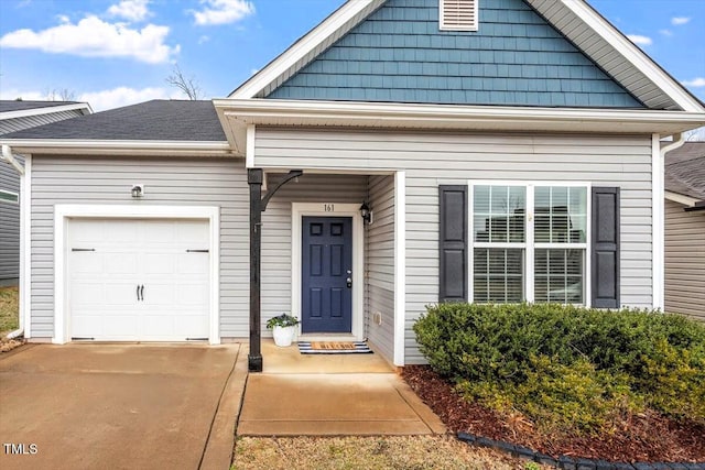 view of front of house with concrete driveway and an attached garage