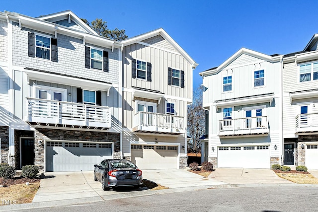 multi unit property with board and batten siding, stone siding, and driveway