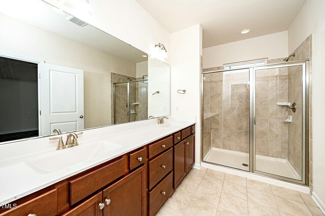 full bathroom featuring a stall shower, visible vents, a sink, and double vanity