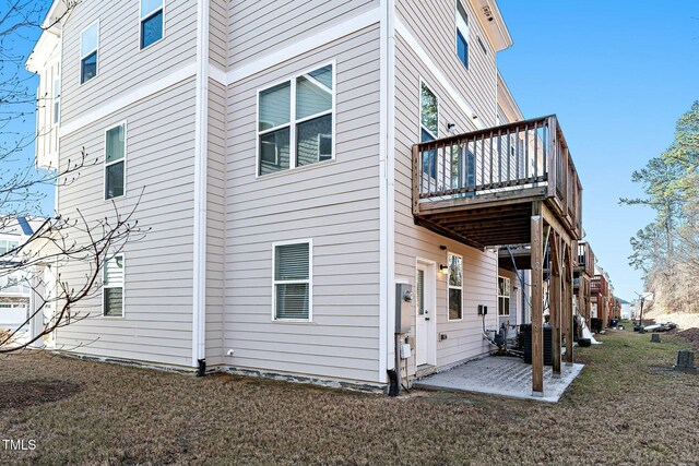 view of side of property with a patio area and a deck