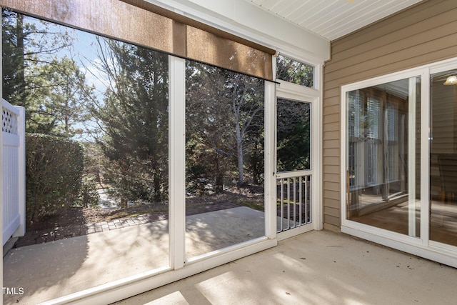 doorway with wood walls and concrete flooring