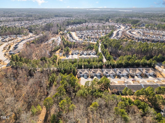 drone / aerial view with a residential view and a view of trees